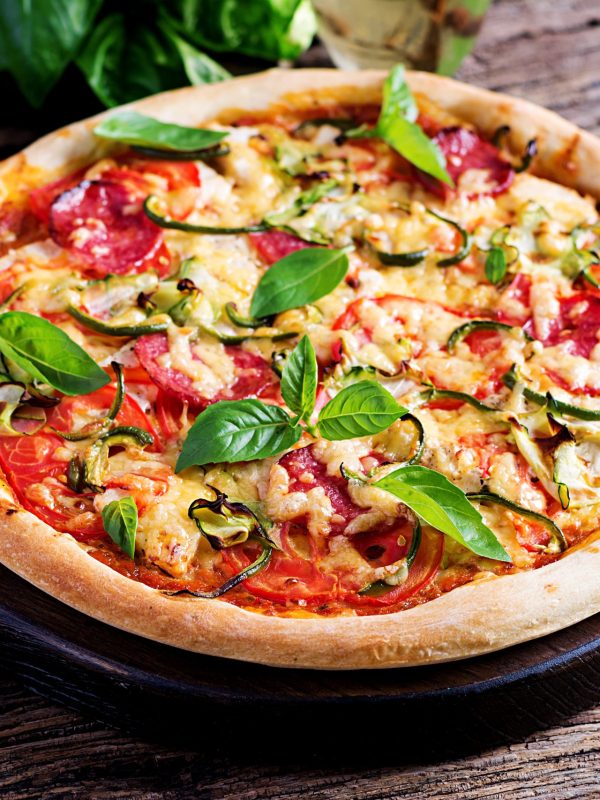 italian-pizza-with-chicken-salami-zucchini-tomatoes-herbs-vintage-wooden-table-italian-cuisine Italian pizza with chicken, salami, zucchini, tomatoes and herbs on vintage wooden background. Italian cuisine